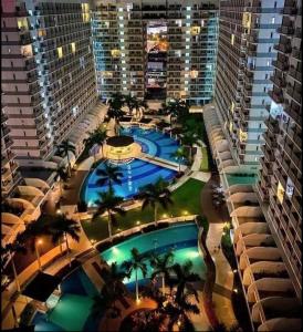 an overhead view of a pool in a city at night at Princess Place at Shell Residences in Manila