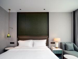 Voodi või voodid majutusasutuse Shenzhen Shanghai Hotel toas