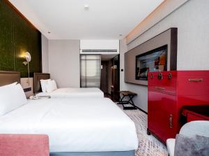 Voodi või voodid majutusasutuse Shenzhen Shanghai Hotel toas