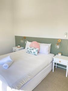 a bed in a bedroom with a white bedspread at Glen Eden Beach Resort in Peregian Beach