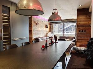 a dining room with a table and two pendant lights at Appartement Val-d'Isère, 4 pièces, 6 personnes - FR-1-518-87 in Val-d'Isère