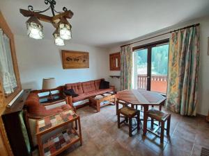 a living room with a couch and a table at Charmant 2 pièces avec balcon et parking au Col du Corbier - FR-1-573-107 in Le Biot