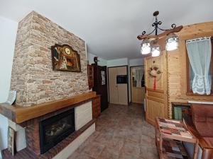 a living room with a fireplace and a stone wall at Charmant 2 pièces avec balcon et parking au Col du Corbier - FR-1-573-107 in Le Biot +8 photos