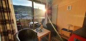 a room with a window with a view of a city at Pension Regina in Cochem