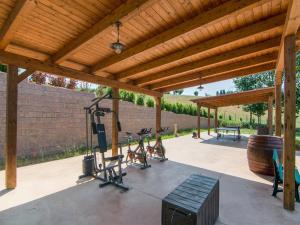 a gym with exercise equipment under a wooden pergola at Holiday Home in Marche region with Private Swimming Pool in Ostra Vetere
