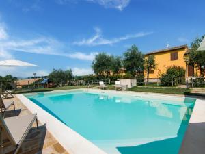 a large swimming pool with blue water at Holiday Home in Marche region with Private Swimming Pool in Ostra Vetere