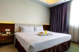 Postel nebo postele na pokoji v ubytování Ixora Hotel Penang