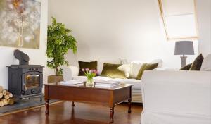 a living room with a coffee table and a fireplace at Courtyard Cottages in Tralee