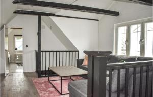 a living room with a couch and a table at 4 Bedroom Cozy Home In Smedstorp in Smedstorp