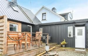 a deck with chairs and a table on a house at 4 Bedroom Cozy Home In Smedstorp in Smedstorp