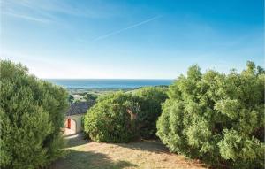 a view of a house with trees and the ocean at Giagumeddu 2 in Badesi