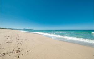 a sandy beach with the ocean in the background at Giagumeddu 2 in Badesi