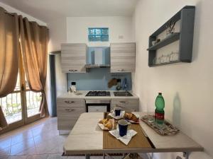a kitchen with a table with food on it at Ely Sea in Belvedere Marittimo