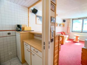 a small kitchen with a counter and a room at Appartement Tignes, 2 pièces, 6 personnes - FR-1-502-288 in Tignes
