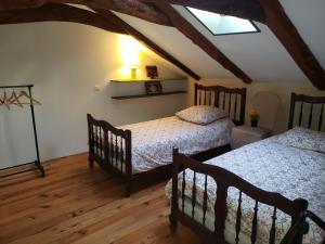 a bedroom with two beds and a skylight at La Chabanade in Saint-Pierre-Eynac +18 photos