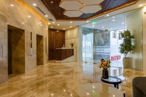 a lobby of a building with a vase of flowers at MARINA SUITES Apartment in Nha Trang