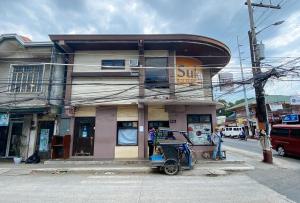 a scooter parked in front of a building at RedDoorz @ Sukitel Budget Hotel Nasugbu in Nasugbu