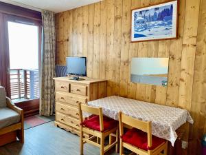 a room with a table with a television and a desk at Studio Tignes, 1 pièce, 3 personnes - FR-1-502-322 in Tignes