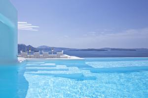 a rendering of a swimming pool with chairs and water at Canaves Ena - Small Luxury Hotels of the World in Oia