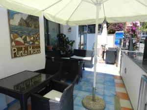a restaurant with tables and chairs and an umbrella at Hotel Punta Mesco in Monterosso al Mare