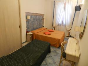 a small room with two beds and a bench in it at Hotel Punta Mesco in Monterosso al Mare