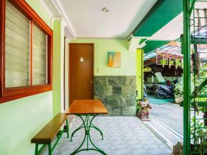 um quarto com uma mesa de madeira e uma janela em OYO 166 Maanyag Pension House em Cebu