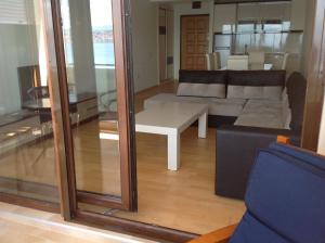 a living room with a couch and a table at Sunnyview Park Ohrid apartments in Ohrid
