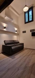 a large living room with a black couch in a room at Kabialde Apartamentuak in Zarautz