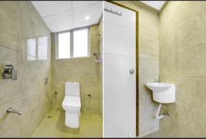 a bathroom with a toilet and a sink at Fly Inn in Bangalore