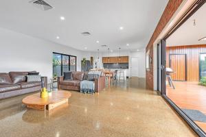 a living room with a couch and a table at Villa Simone - Tranquil Hideaway in the Heart of Echuca in Echuca