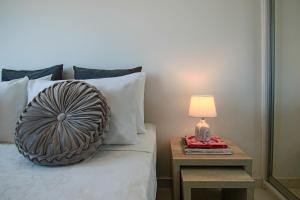 un letto con un tavolino e una lampada sopra di Phaedrus Living: Seaside Luxury Flat Lighthouse 66 a Paphos