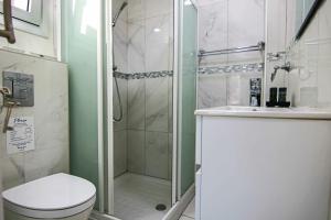 a bathroom with a shower and a toilet and a sink at Phaedrus Living: Seaside Luxury Flat Lighthouse 66 in Paphos