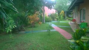 a garden with a walkway next to a house at Gloria's Bed and Breakfast in Livingstone