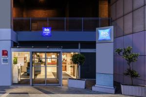 a building with a bus agency sign in front of it at ibis budget Paris Porte de Bercy in Charenton-le-Pont