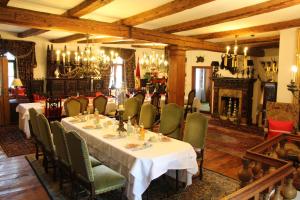 a dining room with tables and chairs and a fireplace at Hotel Altes Rittergut in Sehnde