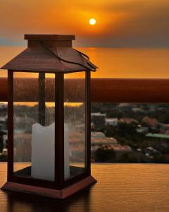a candle in a lantern with the sunset in the background at Il Chiostro in Massa Lubrense