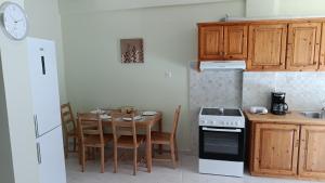a kitchen with a table and a stove top oven at Frygano Apartments 1 in Oitylo