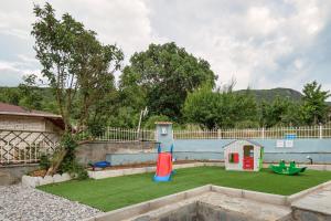 a backyard with a play yard with a playground at Bungalow Episkopiko in Ioannina