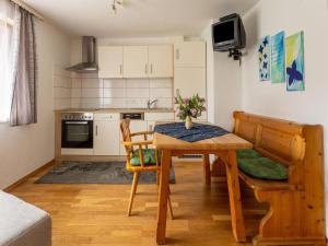 a kitchen and dining room with a table and chairs at Apartment in Tr polach Carinthia with pool in Tröpolach