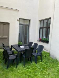 a black table and chairs in the grass at Riga Center Apartment in Old Town in Rīga