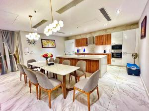 a kitchen with a table and chairs in a room at Oceanami 5 Bedrooms Private Pool in Long Hai