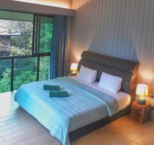 En eller flere senge i et værelse på Permai Rainforest Resort