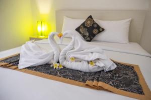 Letto o letti in una camera di Gaing Mas Residence By Gaing Mas Group