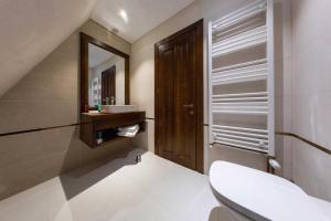 a bathroom with a toilet and a sink and a mirror at CABANELE IULI'S HOME in Runcu +51 photos