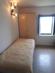 a bedroom with a white bed and a window at rurale in Nocera Terinese