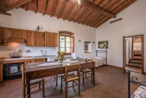 eine Küche mit einem großen Holztisch in einem Zimmer in der Unterkunft Poggio Primo - Bilocale Brando in Castiglion Fibocchi