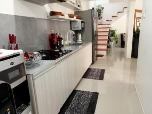 a kitchen with a stove and a counter top at Natalie's Villa in Iloilo City +12 photos