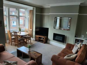 a living room with a couch and a table at Woldgate Retreat Bridlington in Bridlington