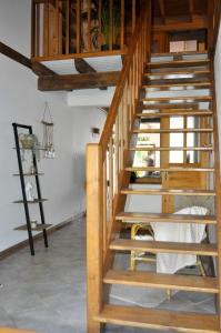 a wooden staircase in a room with wooden ceilings at Les Antonins in Marville