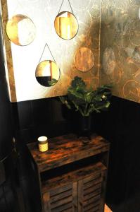 a room with a table with a potted plant and lights at Les Antonins in Marville